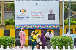 Exterior view of Bharat Mandapam venue in New Delhi decorated with BRICS Summit 2026 flags and official branding.